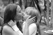 © Anna Jurkovska - Gentle kiss of mother and little daughter at a family party
