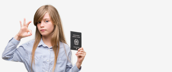 Sticker - Young blonde toddler holding italian passport doing ok sign with fingers, excellent symbol