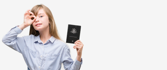 Sticker - Young blonde toddler holding australian passport with happy face smiling doing ok sign with hand on eye looking through fingers