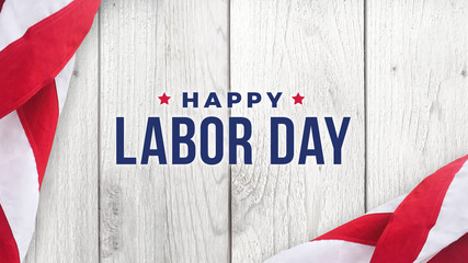 Wall Mural - happy labor day text over white wood wall texture background and american flags