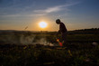 © retbool - working man on the field at sunset