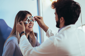 Optometrist checking patient eyesight and vision correction