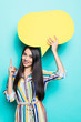 © F8  \ Suport Ukraine - Young woman holding a speech bubble on a blue background