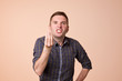 © RealPeopleStudio - Caucasian middle aged man looking angry showing italian gesture over brown background