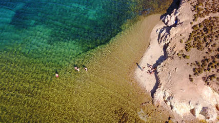 Aerial bird's eye view photo taken by drone of famous rocky beach of Livadi Geranou with turquoise clear waters, Patmos island, Greece