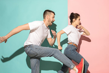 A couple of young man and woman dancing hip-hop at studio.