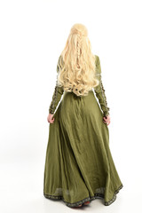 Sticker - full length portrait of blonde girl wearing green medieval gown, standing pose facing away from camera. isolated on white studio background.