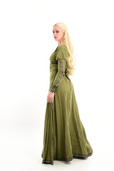 Wall Mural - full length portrait of blonde girl wearing green medieval gown, standing pose facing away from camera. isolated on white studio background.