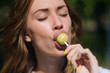 © Vladimir - Beautiful girl sucks Lollipop in summer outdoors