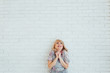 © ruslan_shramko - Blonde happy woman in light dress with stay in front of light wall