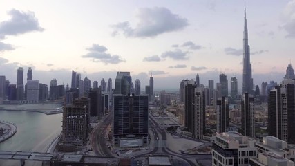 Wall Mural - DUBAI - DECEMBER 2016: Aerial view of Downtown skyscrapers at dusk. The city attracts 20 million tourists annually