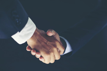 Business partnership meeting concept and business handshake for successful of investment deal on black background