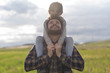 © FotoAndalucia - Padre juega con pequeña hija en día primaveral llevándola a hombros