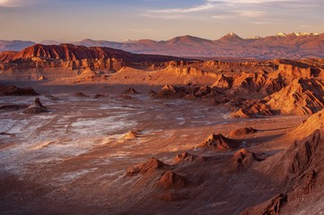 a white van crosses through a highway in a massive moon crater at valle de la luna, or the moon vall