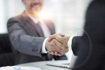 closeup .handshake of business partners above the Desk