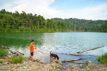  Man and dog playing in the lake