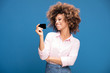 African american woman holding credit card in hand.
