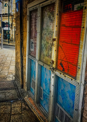 Colorful building exterior covered in safety mesh and locked up in Tel Aviv, Israel.