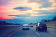 Night traffic. Cars on highway road on sunset evening in busy Toronto city in Canada. Beautiful amazing night urban view with red, yellow and blue sky clouds. Toned with film filters