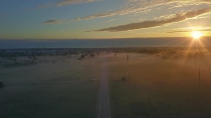 Wall Mural - beautiful aerial shot of thick layer of fog on fields during sunrise with expanse and endless skylin