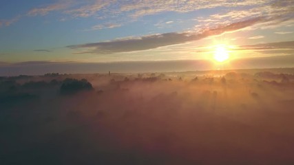 Wall Mural - beautiful aerial shot of thick layer of fog on fields during sunrise with expanse and endless skylin