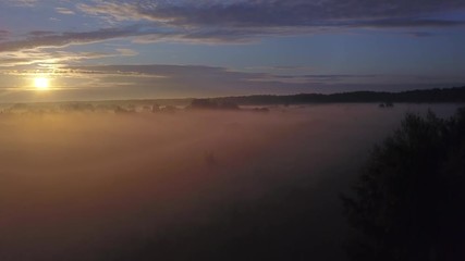 Wall Mural - beautiful aerial shot of thick layer of fog on fields during sunrise with expanse and endless skylin