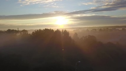 Wall Mural - beautiful aerial shot of thick layer of fog on fields during sunrise with expanse and endless skylin