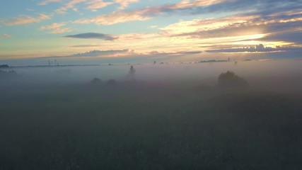 Wall Mural - beautiful sunrise, fog on field in nature with colorful clouds on background
