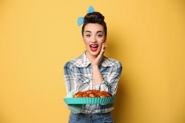 Poster - Funny young housewife with homemade pastry on color background