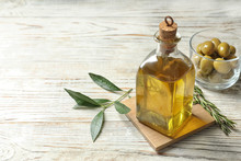 Bottle With Fresh Olive Oil On Table