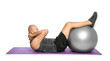 © New Africa - Overweight man doing exercise with fitness ball on white background