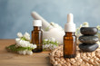 © New Africa - Composition with essential oil, spa stones and flowers on table