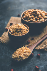 Wall Mural - Crushed peanuts or mungfali powder with whole and roasted groundnut. Served in a bowl over moody background. Selective focus