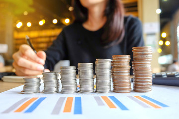 Close up of yong asian female business owner making calculations. Savings, finances and economy concept