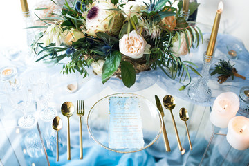 Wall Mural - Little round table prepared for romantic dinner stands before a window with panoramic view