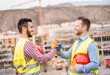 Builders on residential construction site making a deal - Happy workers are satisfied of their plan - Dealing, real estate, engineer, industrial and building houses concept