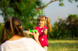 © Svetlana - Young mother and little daughter playing in park with soap bubbles. Love family, parenthood, childhood