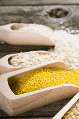 Wall Mural - raw cereal foods: millet, brown and white rice, flour, oatmeal grains on old wood background