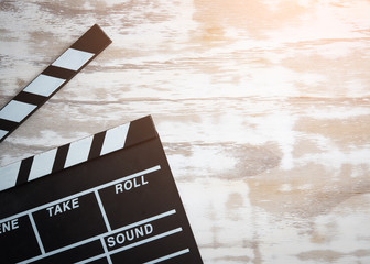Movie clapper board on wooden table background,top view