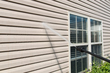 Power Washing. House Wall Siding Cleaning With High Pressure Water Jet.