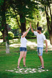 © nagaets - A young couple celebrate victory playing tic-tac-toe in the park