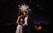 © VlaDee - Wedding fireworks. Bride and groom hugging in the night on firework and salute background, wedding party