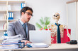 © Elnur - Businessman working with skeleton in office