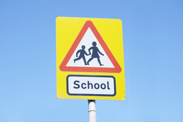 school warning sign blue sky red triangle road safety children young kids parents