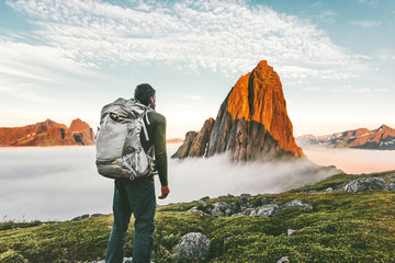 Wall Mural - Backpacker man exploring sunset rocky mountains alone hiking adventure journey summer vacations traveling lifestyle weekend getaway