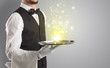 © ra2 studio - Elegant young waiter serving mysterious light on tray