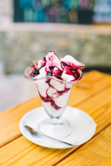 Ice cream in two retro metal bowls on a wooden table.