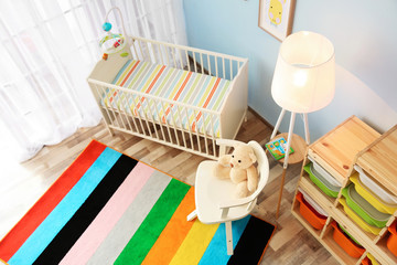 Wall Mural - Modern interior of light cozy baby room with crib, view from above