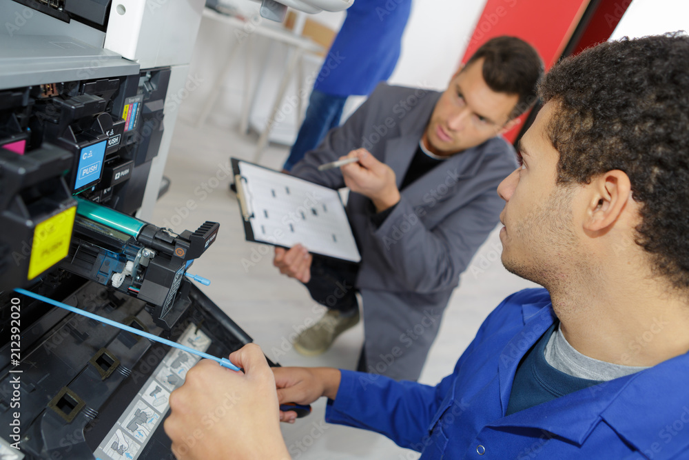 young apprentuce fixing office printer with teacher Stock Photo | Adobe ...