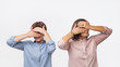 © Viktor Koldunov - Two european women mother and daughter covering their faces using hands. We are spying on you concept